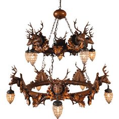 a chandelier with deer heads hanging from it's sides and lights on each side