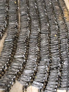 several rows of metal objects sitting on top of a floor next to eachother