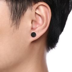 a close up of a person's ear with a black dot on the side