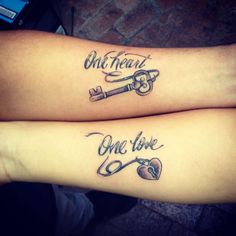 two people with tattoos on their arms that say one heart, one love and key