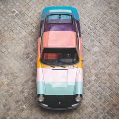 an overhead view of a multicolored car parked on the side of a road