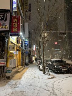 a snowy street with cars parked on it