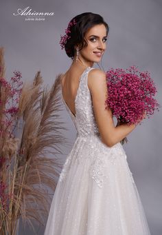 a woman in a wedding dress holding flowers