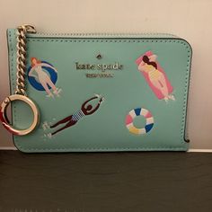 Kate Spade Aqua Blue Leather Medium Zip Wallet Card Case Keychain Brand New W/Tags Msrp $159 Poolside Leather Perfect Size To Carry Money, Credit Cards, I.D., Keys 4 Credit Card Slots, 1 Full Width Pocket Zip Across Top And Down Side Gold Plated Hardware Interior Is Ks Beige Satiny Fabric Measures 5” X 3.25” All Items From A Smoke & Pet Free Environment Blue Coin Purse With Interior Card Slots, Blue Rectangular Coin Purse, Trendy Blue Coin Purse For Travel, Trendy Kate Spade Wallet With Card Slots, Trendy Kate Spade Wallets With Card Slots, Trendy Blue Pouch Wallet, Trendy Kate Spade Rectangular Wallet, Travel Coin Purse With Interior Key Chain Holder, Kate Spade Coin Purse For Daily Use