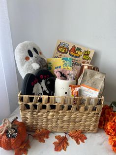 a wicker basket filled with items on top of a table next to an orange flower