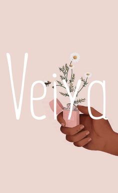 a hand holding a vase with daisies in it and the word vegan above it