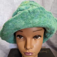 This One Of A Kind Hat Is Light Green With Accents Of Darker Green And Yellow. It Can Be Worn As A Beanie, Or The Brim Can Be Flipped Up. The Wool Felt Is Thick And Warm, Perfect For Winter. It Was Made By Hand Using A Wet Felting Process Which Takes Wool Roving, Accents Of Silk, Hot Water, Natural Soap, And A Lot Of Massaging Until It Is A Fabric. It Is Brand New Without Tags. Green Mini Hats, Handmade One-size Cloche Hat With Short Brim, Whimsical Handmade Green Hat, Artisan Green Hat With Flat Brim, Green Artisan Handmade Hat, Handmade Artisan Green Hat, Whimsical Green Ladies Hat, Green Short Brim Hat, Green Felt Brimmed Hat