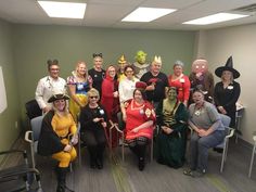 a group of people in costumes posing for a photo