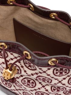 Find TORY BURCH T Monogram Bucket Bag on Editorialist. This Tory Burch bucket bag is crafted from calf leather and bouclé. It features embossed crocodile effect panels, gold-tone hardware, a slip pocket to the rear, an open top with a front toggle fastening, a logo toggle detail, a single top handle, an adjustable detachable shoulder strap, an internal logo stamp, a main compartment, an internal slip pocket, suede lining, and metal feet. Tory Burch Bucket Bag, T Monogram, Purple Bags, Logo Stamp, Open Top, Top Handle, Calf Leather, Bucket Bag, Tory Burch