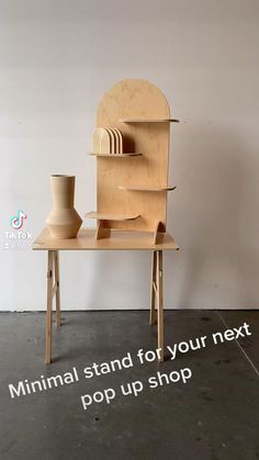 a wooden table with two vases on it and the words minimal stand for your next pop up shop