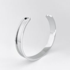 Elevate your style with this business casual Greek-inspired stainless steel forearm cuff bracelet! Its minimalist design is perfect for pairing with any summer look, and its slightly adjustable sizing ensures a comfortable fit for any wrist size! Crafted from durable stainless steel, this cuff is both elegant and versatile. Its sleek silver finish is perfect for stacking with other cuffs or bangles, making it a must-have addition to your jewelry collection. This cuff is the perfect gift for special occasions like weddings, birthdays, and anniversaries. Its unique design makes it a thoughtful proposal gift, or a stylish treat for yourself. Whether you're looking for a statement piece to complete your outfit or a timeless addition to your jewelry collection, this stainless steel cuff is sure Adjustable Stainless Steel Bangle With Polished Finish, Adjustable Stainless Steel Cuff Bracelet For Formal Occasions, Polished Stainless Steel Bangle Cuff Bracelet, Polished Stainless Steel Cuff Bracelet, Stainless Steel Polished Cuff Bracelet, Adjustable Nickel-free Minimalist Bangle, Adjustable Metal Bangle In Minimalist Style, Adjustable Minimalist Metal Bangle, Minimalist Metal Cuff Bracelets