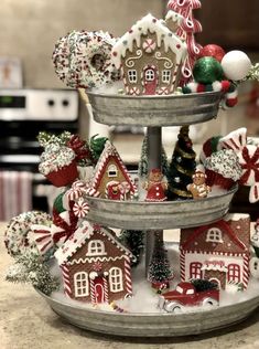 three tiered tray with christmas decorations on it