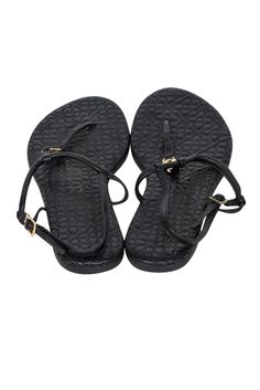 Get ready for vacation with these resort-ready black strappy sandals by Tory Burch. The luxe quilted leather design exudes elegance while the gold-tone logo detail adds a chic touch. Perfect for warm weather- simply slip them on with your favorite sundress or bikini and go! Size 8 Leather upper & insole Synthetic outer sole Quilted medallion footbed Thong style Gold-tone hardware detail Adjustable ankle strap w/ buckle closure Dust bag included Elegant Beach T-strap Sandals With Adjustable Strap, Luxury Black Sandals With Adjustable Strap, Elegant Black Sandals With Adjustable Straps, Elegant Beach Sandals With Adjustable Straps, Luxury Synthetic Sandals For The Beach, Luxury Synthetic Beach Sandals, Black T-strap Sandals With Adjustable Strap For Vacation, Luxury Synthetic Sandals For Vacation, Black T-strap Sandals With Adjustable Straps