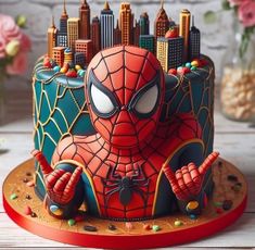 a spiderman birthday cake with sprinkles on it and the city in the background