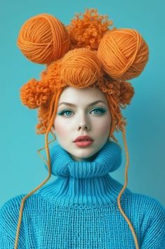 a woman with orange hair and blue sweater is wearing balls of yarn on her head