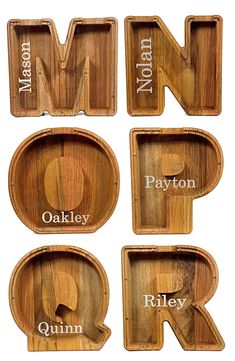 four wooden trays with different types of letters and numbers on them, all in the same