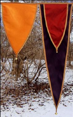 three different colored flags hanging in the snow