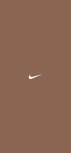 a white nike logo is on a brown background and it appears to be in the air