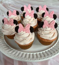 cupcakes decorated with minnie mouse ears on a plate