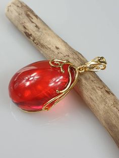 Deep Red amber pendant. Perfect stunning ruby red teardrop shape. Gold plated pendant (with stamping-hallmark). High quality. Teardrop shape elegant pendant. All natural parts, not plastic. Weight: 14.00 gr Pendant size: 5.5 x 2.6 cm MATCHING Earrings: https://www.etsy.com/uk/listing/912802337/ruby-red-amber-earrings-gold-plated?ref=shop_home_active_4&frs=1 This item was made of natural Baltic Amber. All the amber used in my jewelry is collected in my home country Lithuania. I sell only genu Red Ruby Drop Jewelry, Cabochon Drop Jewelry For Gifts, Red Drop Beads For Jewelry Making, Red Drop Gemstone Jewelry, Red Gemstone Drop Jewelry, Unique Red Cabochon Jewelry, Elegant Red Jewelry With Cabochon, Elegant Red Oval Pendant Jewelry, Elegant Red Cabochon Jewelry