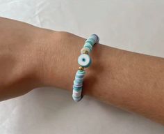 a person's arm with a bracelet on it