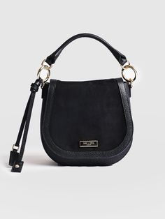 A classic saddle bag in black, made with the softest Italian leather and suede for a chic look and feel. Handmade in our studios in Europe in small numbers to guarantee the perfect finish. Durable and water resistant, this is a classic style you can wear in years from now. Finished with golden hardware and given a refined polish. A small occasion bag that's perfect for work or weekends. Black Leather Saddle Bag With Gold-tone Hardware, Luxury Black Saddle Bag In Soft Leather, Chic Satchel Shoulder Bag With Suede Lining, Chic Suede Satchel With Soft Leather, Black Suede Bag With Detachable Strap, Chic Shoulder Bag With Suede Lining For Work, Versatile Leather Saddle Bag For Evening, Leather Saddle Bag With Detachable Handle For Work, Chic Leather Saddle Bag For Work