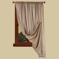 an open window with a curtain and stars on the top of it, in front of a beige wall