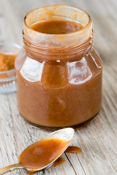 a jar of peanut butter next to two spoons