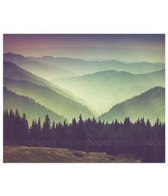 the color palette is green, purple and grey with mountains in the background at sunset