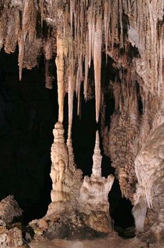 the inside of a cave with stalate formations and icicles hanging from it