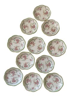 six plates with pink flowers on them are arranged in the shape of a flower arrangement