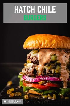 a cheeseburger is stacked on top of other burgers with the words, hatch chile burgers