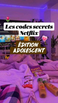 the bed is covered with blankets and other items in front of a television screen that reads les coders secrets negliix