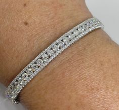 Stunning Diamond Bangle Bracelet White Gold. Simple and classy bangle diamond bracelet fit for a queen. Excellent craftsmanship, the diamonds are very sparkling. You can see the sparkles from across the room. Diamonds all set nice and smooth, won't catch on things. Very comfortable bracelet to wear. Measures 6mm width. The center row of diamonds are good sizes and clean diamonds. No black carbon spots even when viewed under a magnifying glass. This is an heirloom quality bracelet. One Only! Whol Bangle Diamond, Bracelet White Gold, Gold Bangles For Women, Diamond Bangle Bracelet, Diamond Bangles Bracelet, Diamond Bangle, Magnifying Glass, Round Brilliant Cut Diamond, Gold Bangles