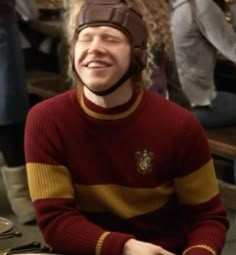 a man wearing a helmet sitting at a table