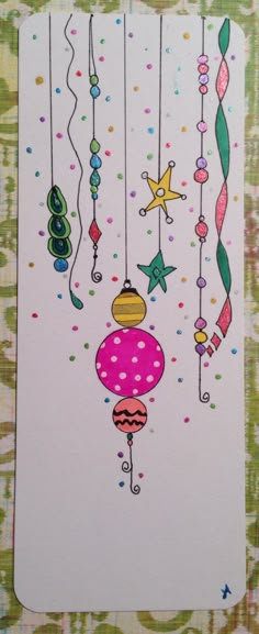 a card with an ornament hanging from it's strings and stars in the background