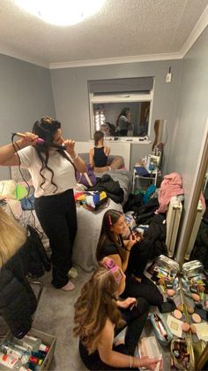 a group of women sitting on top of a couch in a living room next to each other