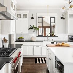 the kitchen is clean and ready for us to use it's white cabinetry