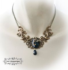 "♥♥Noir Romantique♥♥ Welcome to my store! \"Eternal beauty \"necklace A necklace comprised of 2 bronze rococo flourishes (42x22mm each) perfect detailed set on the left and right of bronze crown setting that is placed upon a central ornament in the middle and finally holds a get black gem 25x18mm. Flourish detail is attached to the gem. Black teardop bead is hanging. ------- If you need a specific lenght contact me :) ------------ ♥♥ The metal parts are of high quality brass ♥♥ Nickel and lead f Gothic Gold Pendant Necklace, Gothic Gold Filigree Jewelry, Gothic Bronze Jewelry With Antique Finish, Gothic Black Necklace For Fantasy Events, Black Gothic Necklace For Fantasy Events, Bronze Metal Fantasy Necklace, Fantasy Style Bronze Metal Necklace, Gothic Pendant Necklace With Antique Finish, Gold Fantasy Style Necklace For Fantasy Events