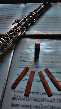 a flute and some music sheets on a table