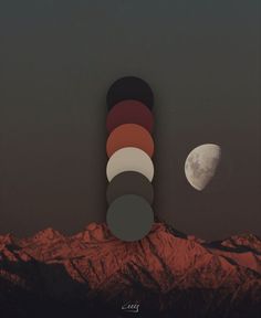 the moon is rising over some mountains in the night sky with an orange and red hue