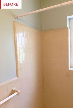 an empty bathroom with white tile on the walls