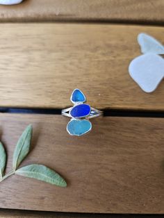 Shades of blue seaglass ring. The sea glass for this ring was hand picked from The Warren Beach in Folkestone, UK. The glass is beautifully rounded by the sea and set in a fine silver bezel, accented by a split shank band. This ring is a size 8.5 US. The ring in the photos is the one you will recieve. This ring would make the perfect gift for any occasion for a sea or beach lover or why not treat yourself! With this ring, you or your loved ones can always carry a tiny piece of the ocean with the Sea Glass Ring Diy, Silver Sea Glass Ring For Beach, Adjustable Silver Ring With Sea Glass, Adjustable Sea Glass Ring Jewelry, Handmade Adjustable Sea Glass Rings, Maya Jewelry, Seaglass Jewellery, Ring Inspo, Sea Glass Ring