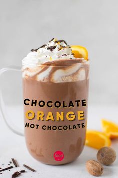 a hot chocolate drink with whipped cream and orange slices