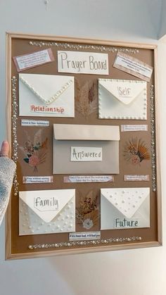 a person is holding up a bulletin board