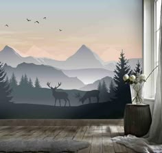 a room with a large window and some deer on the mountain wallpapers in it