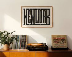 a record player sitting on top of a wooden dresser