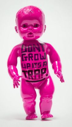 a pink plastic toy with the words don't grow up to be troll on it