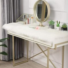 a vanity with a mirror, potted plant and other items