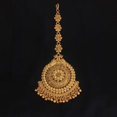 *PRODUCT DETAIL* * Material: Brass * Plating: Gold Plated *DIMENSIONS * * Weight 36 gm Each, Length 2.6 Inches, Width 2.2 Inches, Top Chain Length: 2.6 Inches *ABOUT PRODUCT* * Beautiful Gold Plated Temple Maang Tikka. * Style Tip : An exclusive piece to reflect your tasteful Self. *DISCLAIMER* * Product & color may slightly vary due to photographic lighting sources or your screen settings. Mang Tika Design In Gold Latest, Gold Maang Tika Design, South Indian Maang Tikka Gold, Gold Maangtika Designs, Latest Gold Maang Tikka Designs, Gold Tika Designs For Bride, Gold Mang Tikka Design, Maang Tikka Bridal Gold South Indian, Mangteeka Designs Gold